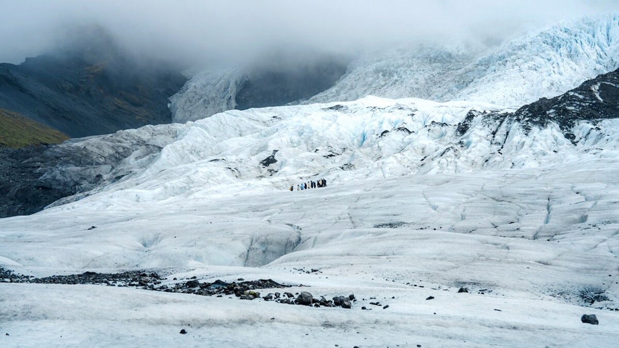 Vatnajökull Glacier with hikers exploring the icy landscape in Iceland.