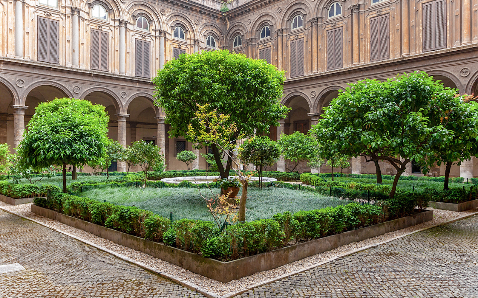 Doria Pamphilj Courtyard with lush greenery and historic architecture in Rome.