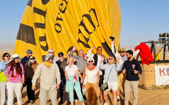 Group of tourists preparing for a hot air balloon ride in Wadi Rum desert.