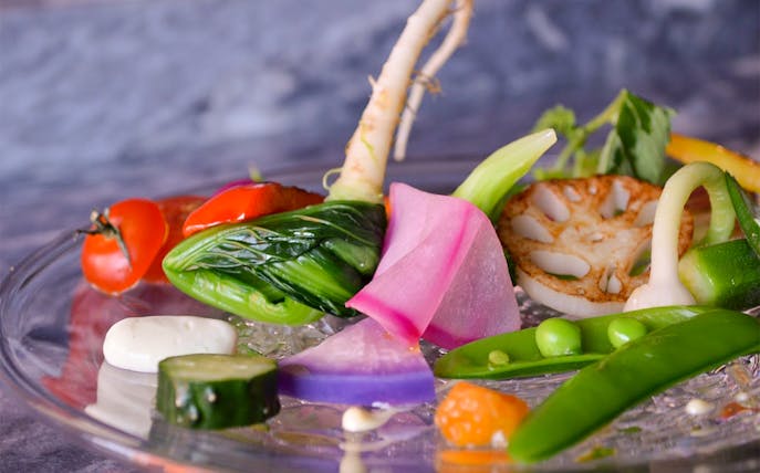 Assorted fresh vegetables on a glass plate at Akasaka NonTitle, Tokyo.