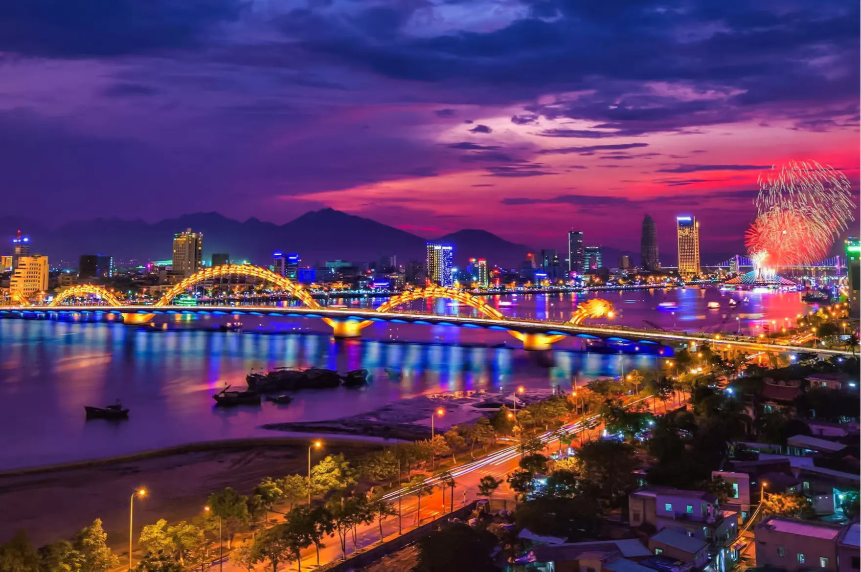 Dragon Bridge illuminated at night with fireworks in Da Nang, Vietnam.