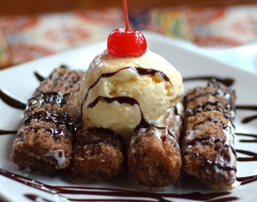 Delicious Spanish churros with ice cream served during a food tour in Madrid