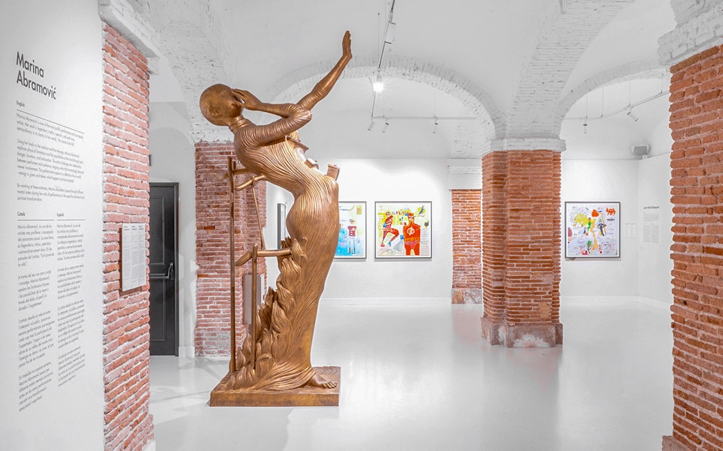 Bronze sculpture and artworks in Moco Museum Barcelona exhibition space.