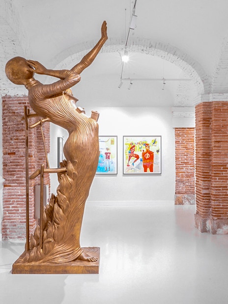 Bronze sculpture and artworks in Moco Museum Barcelona exhibition space.
