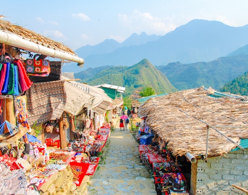 Street market in Cat Cat Hmong village, Sapa, Vietnam, displaying colorful traditional clothes.