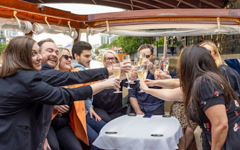 Passengers toasting with champagne on a Yarra River sunset cruise in Melbourne.