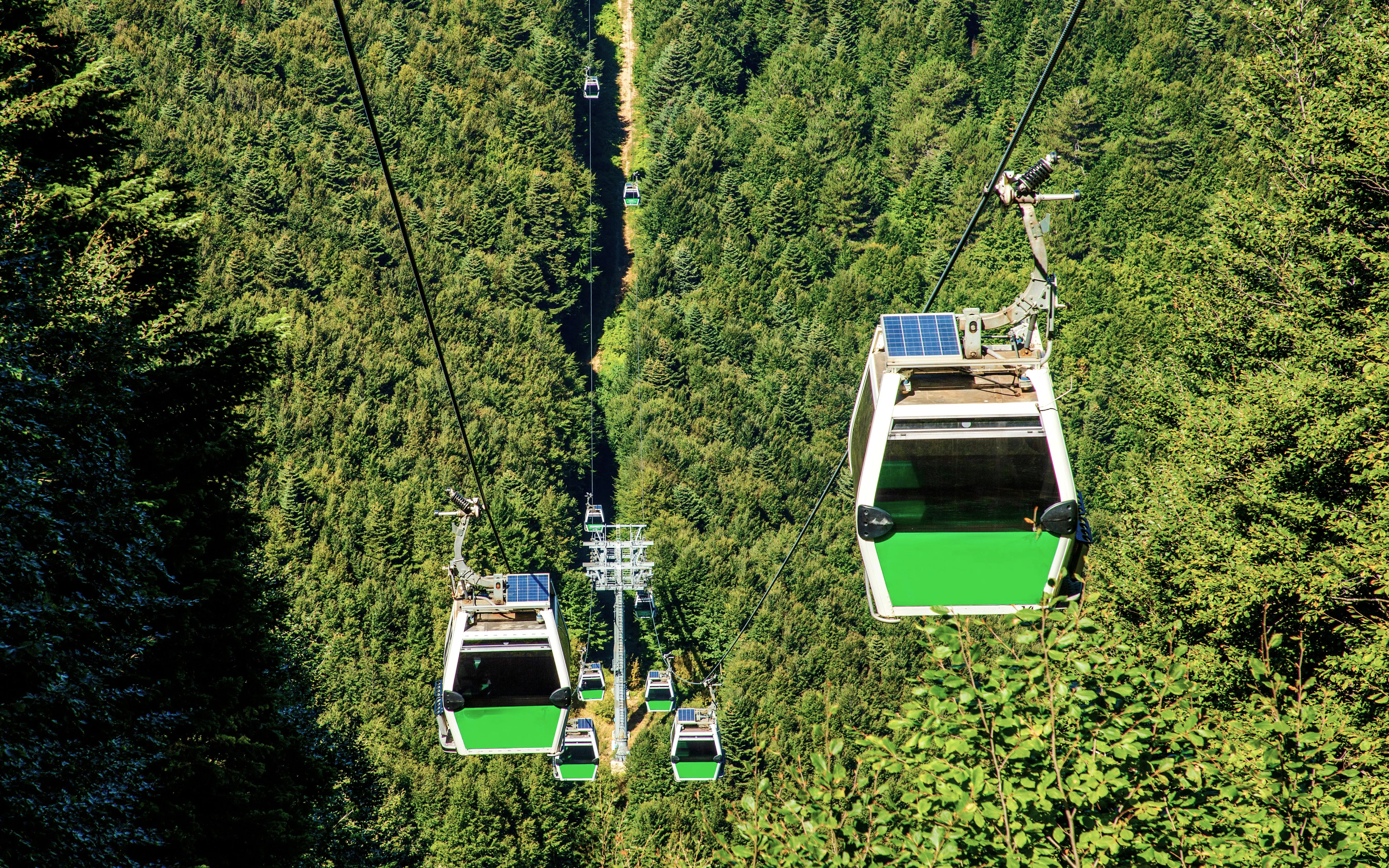 Uludag cable car over green forest in Bursa during summer.