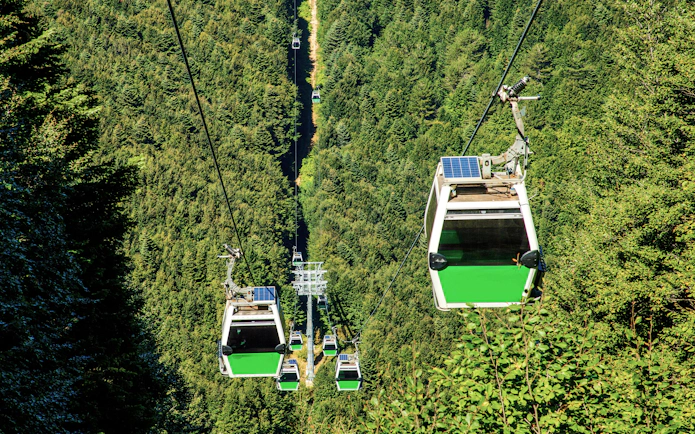 Uludag cable car over green forest in Bursa during summer.