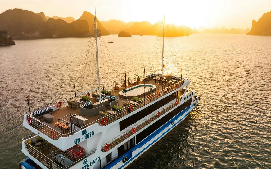 5-star La Casta cruise ship on Ha Long Bay at sunset.