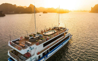 5-star La Casta cruise ship on Ha Long Bay at sunset.