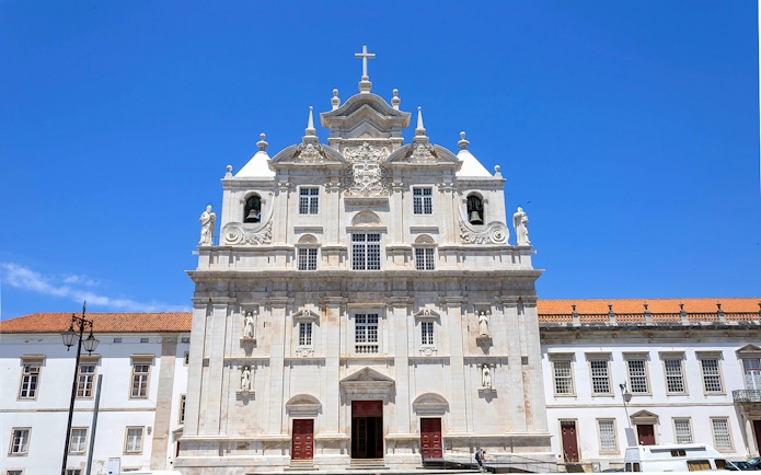 Se Nova Cathedral facade in Coimbra under clear blue sky.