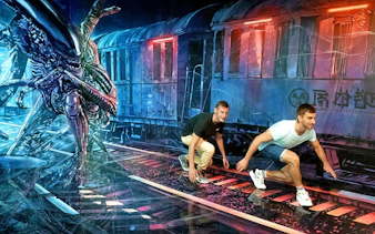 Visitors interact with an alien-themed illusion at Big Fun Museum & Museum of Illusions.