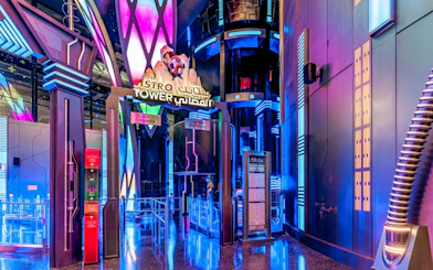 Spike's Astro Tower entrance with neon lights at Doha Quest, Qatar.