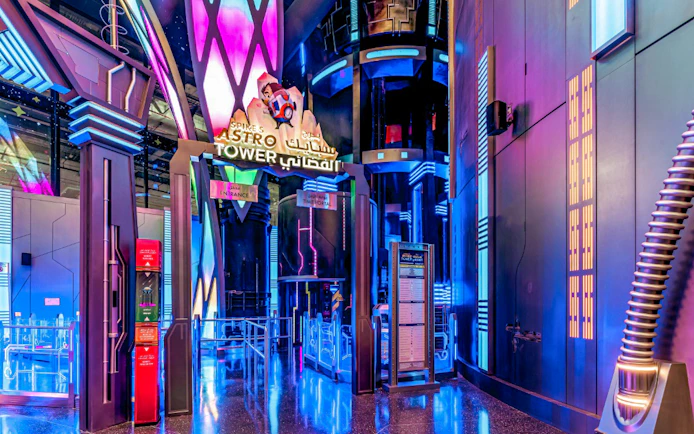 Spike's Astro Tower entrance with neon lights at Doha Quest, Qatar.