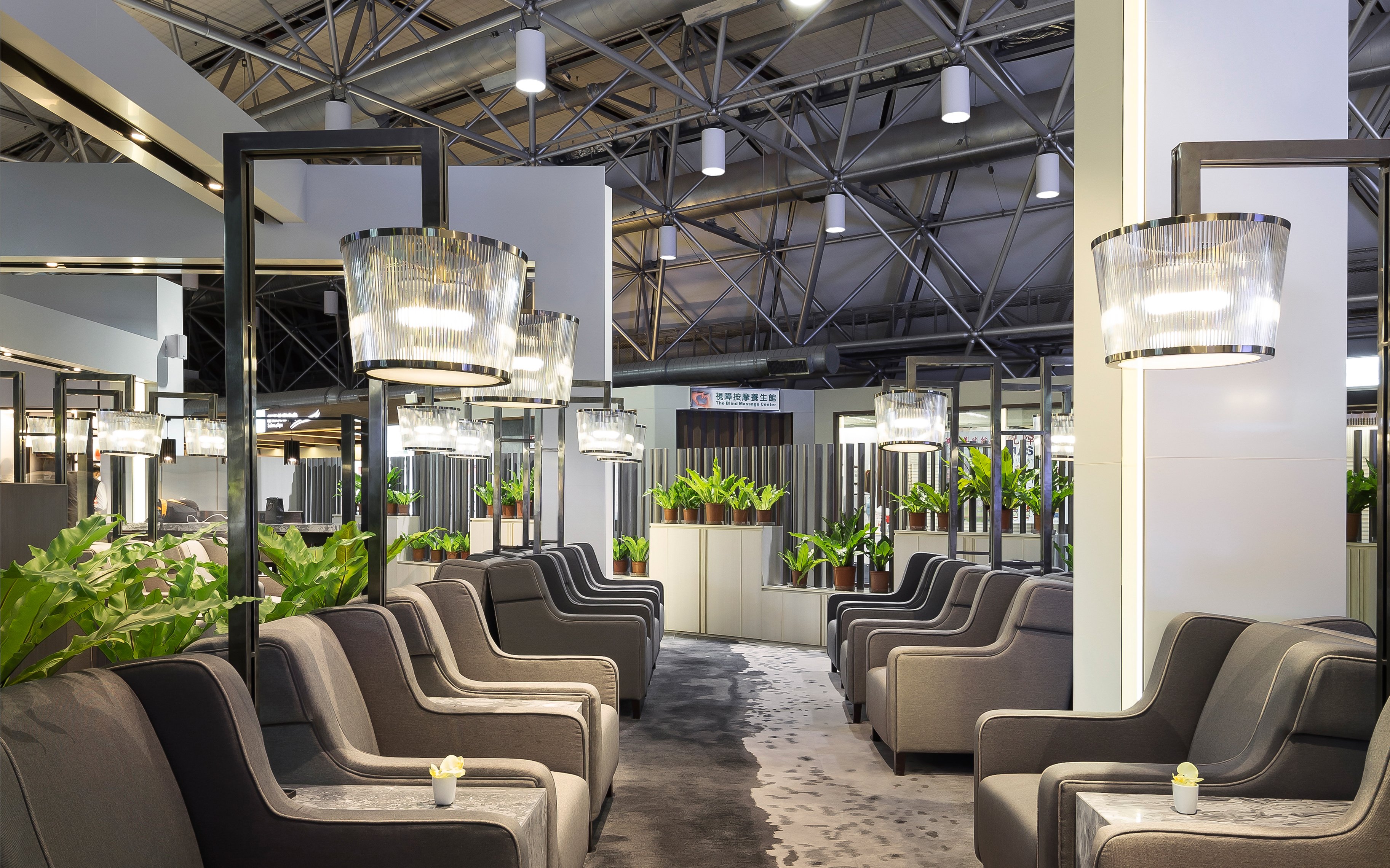 Plaza Premium Lounge seating area with modern lighting and plants, Zone A1, Taipei, Taiwan.