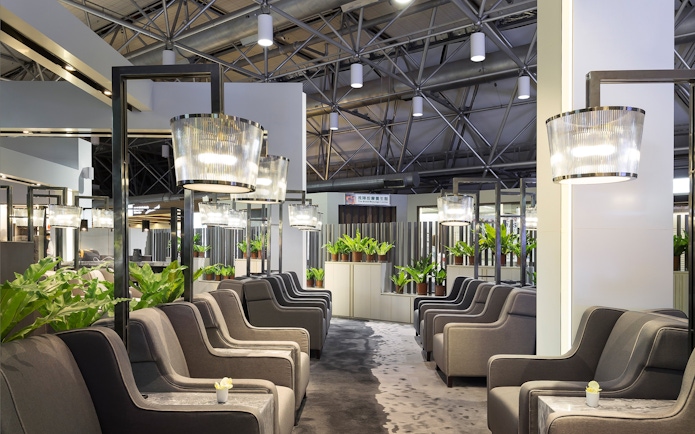 Plaza Premium Lounge seating area with modern lighting and plants, Zone A1, Taipei, Taiwan.