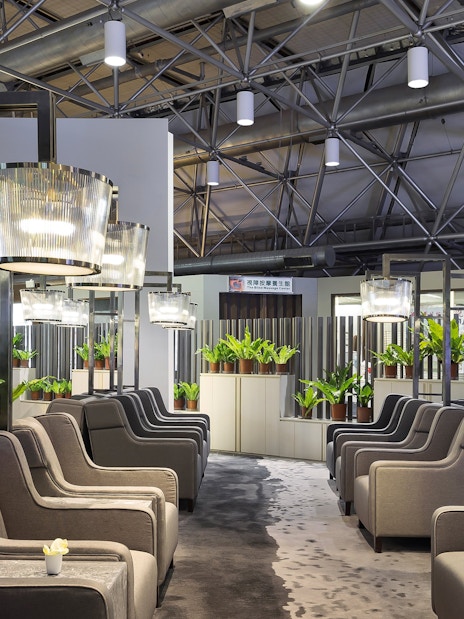 Plaza Premium Lounge seating area with modern lighting and plants, Zone A1, Taipei, Taiwan.
