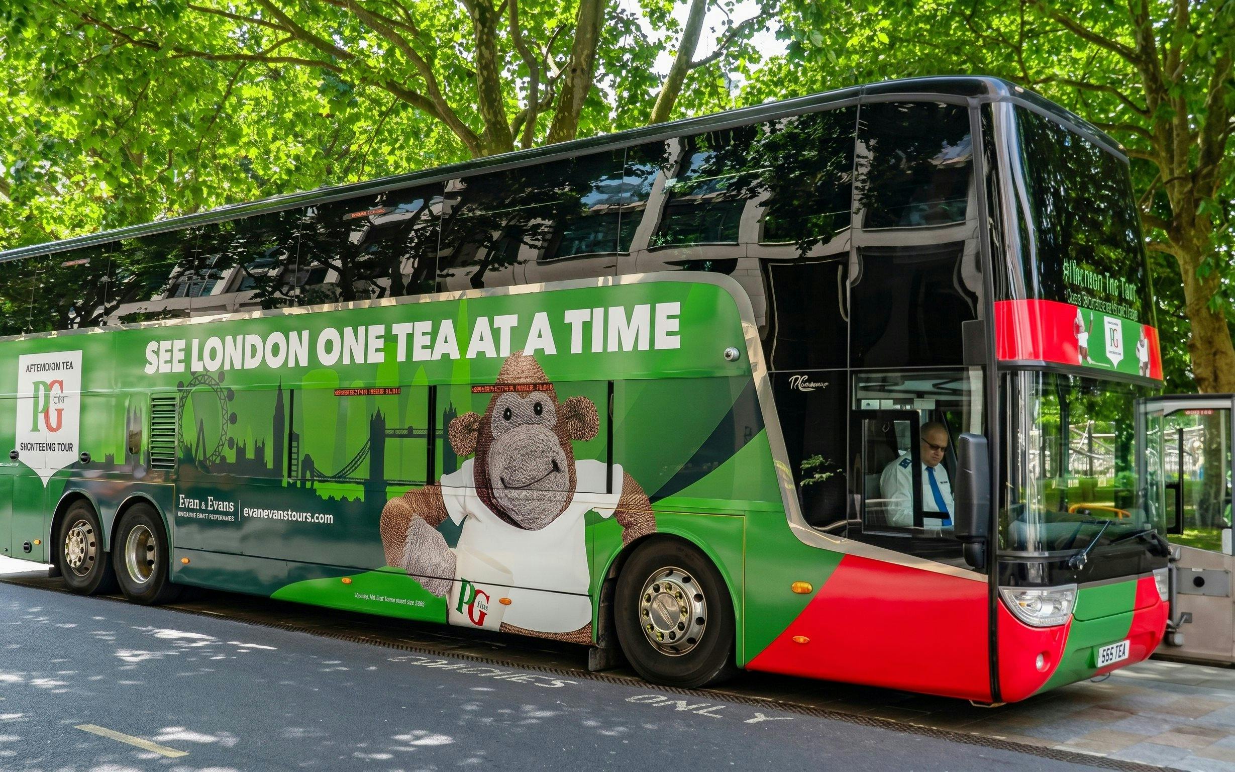 London sightseeing bus with tea-themed design parked under trees.