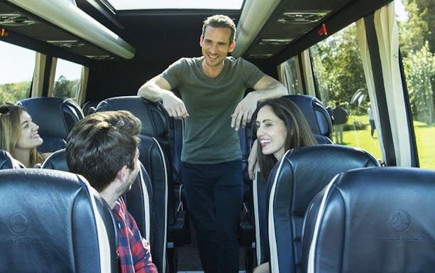 Tour group enjoying a scenic bus ride in the Cotswolds.