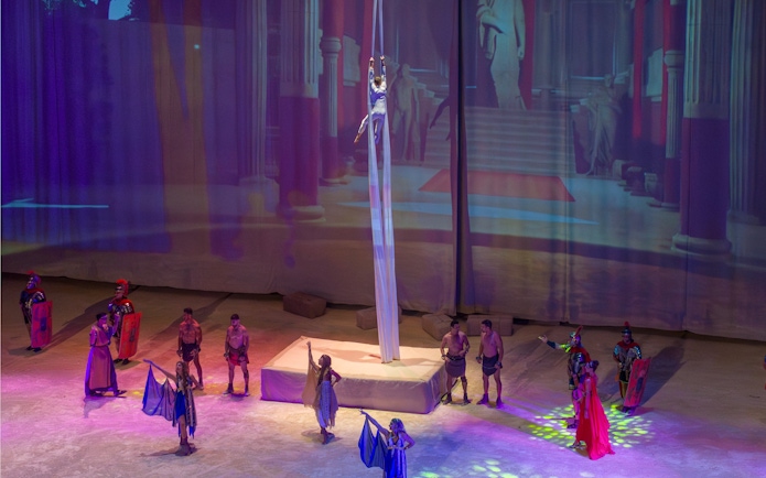 Aerial performer and actors in Roman-themed show at Terra Mitica Benidorm.