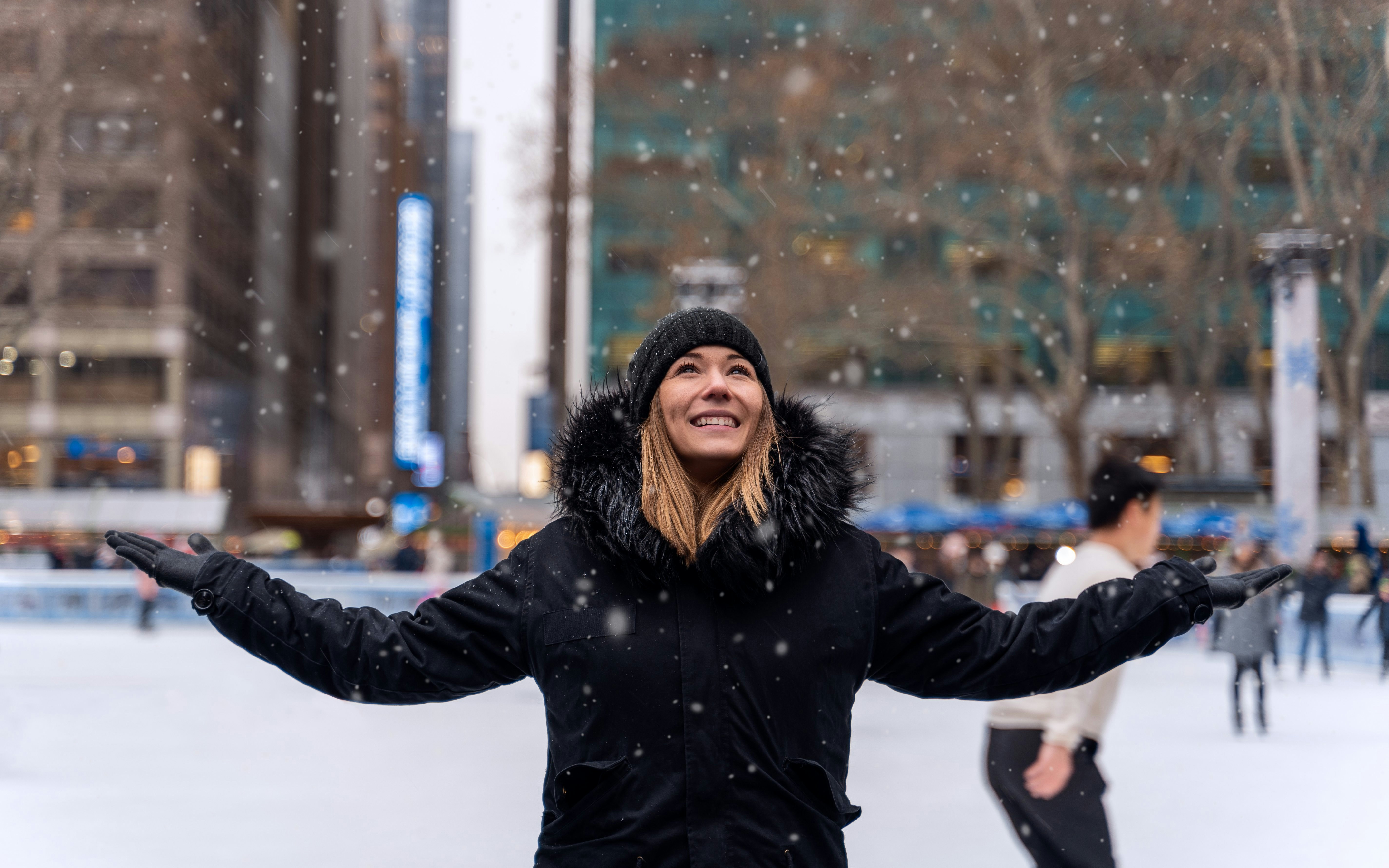 Person enjoying snow at Wollman Rink, Central Park, New York.