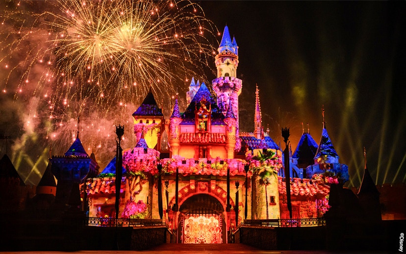 Fireworks illuminate Disneyland Castle at night in Disneyland Park, California.