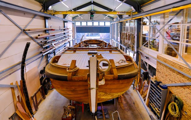 Restoration of traditional botter fishing boat inside Botterwerf workshop.