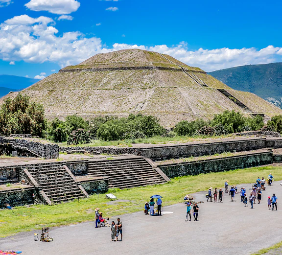 Teotihuacán Pyramid of the Sun with tourists exploring the ancient site in Mexico City.