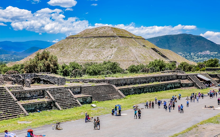Teotihuacán Pyramid of the Sun with tourists exploring the ancient site in Mexico City.