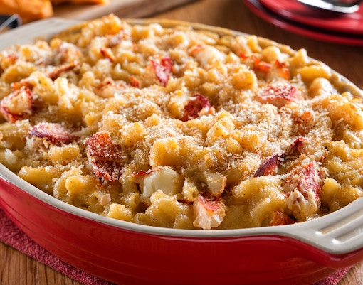 Lobster mac and cheese in a red dish at Secret Caverns dining experience.