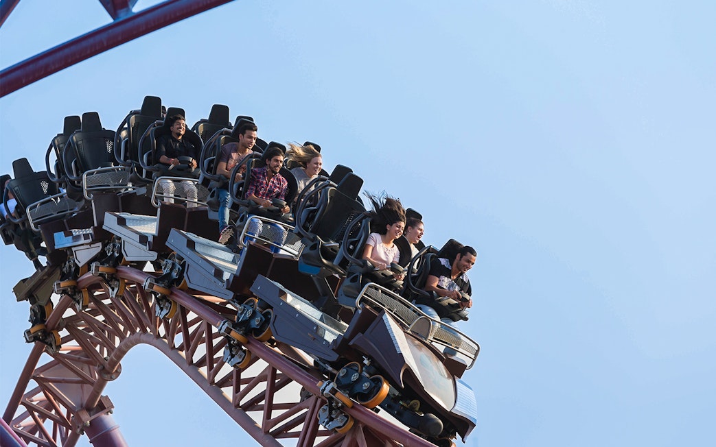 Group enjoying a roller coaster ride at a Dubai amusement park.