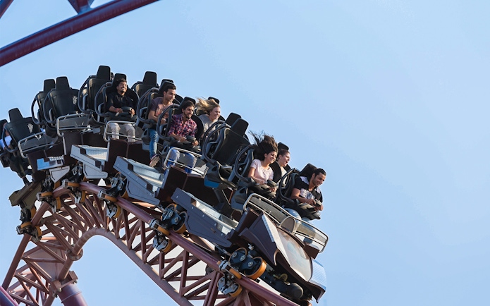 Group enjoying a roller coaster ride at a Dubai amusement park.