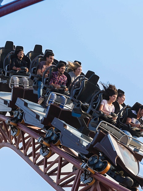 Group enjoying a roller coaster ride at a Dubai amusement park.