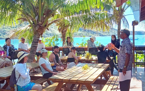 Marine biologist presenting on Marine Sanctuary management to a group on Kuata Island, Fiji.
