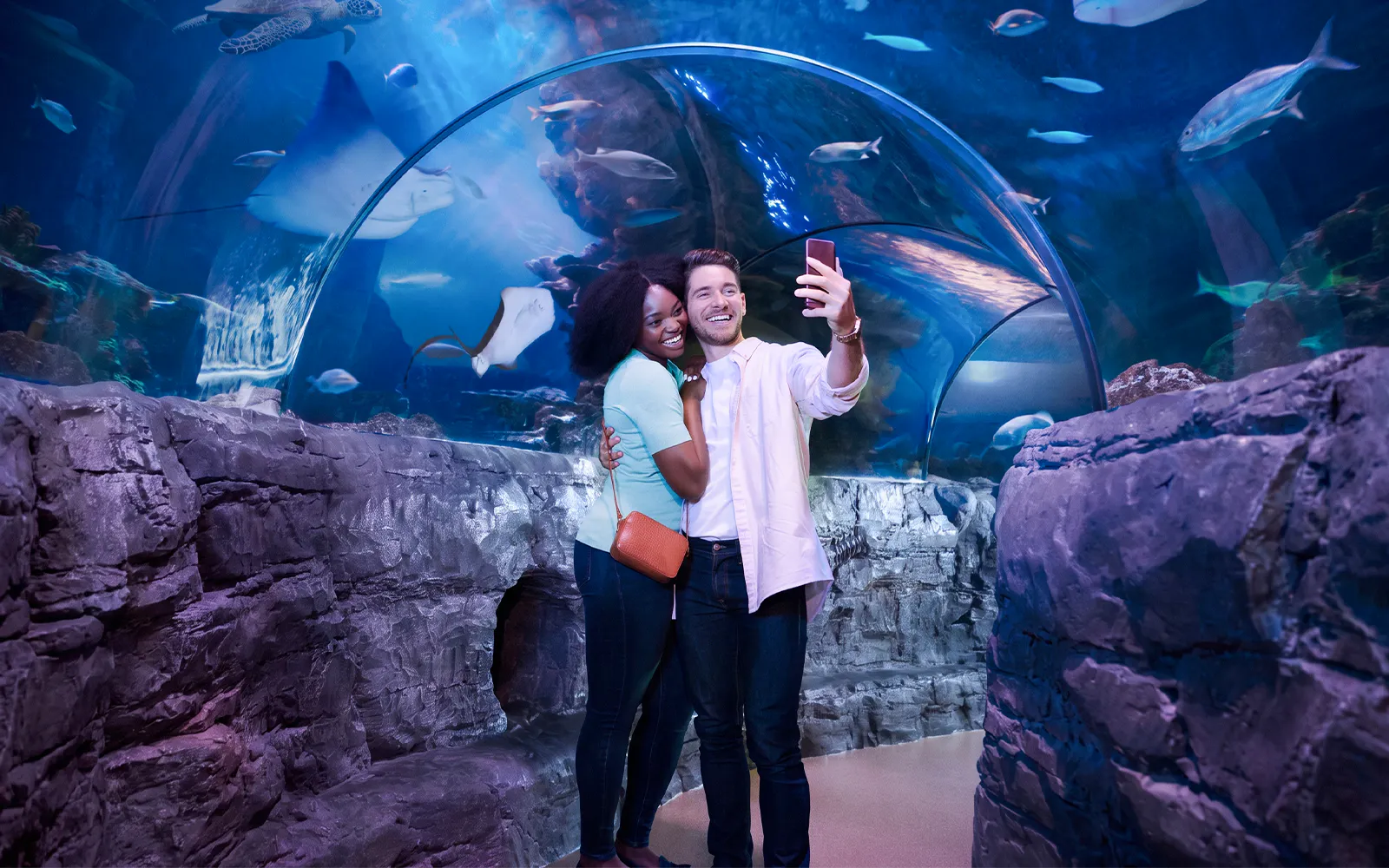 Couple taking selfie in underwater tunnel at Sea Life New Jersey.