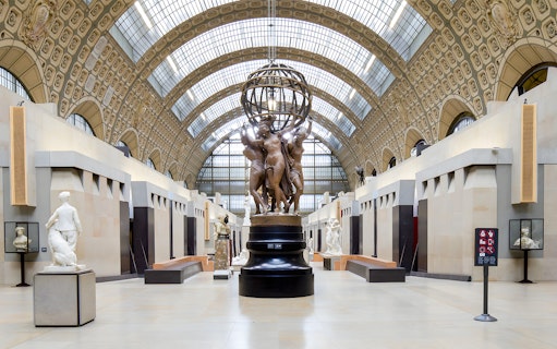 Visitors viewing sculptures in the grand hall of the Orsay Museum, Paris.
