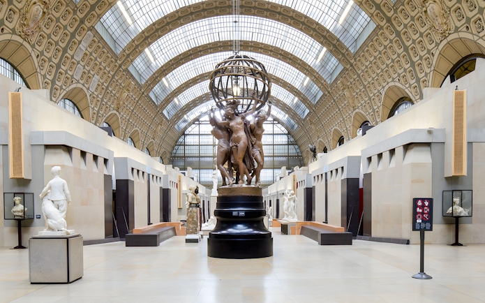 Visitors viewing sculptures in the grand hall of the Orsay Museum, Paris.