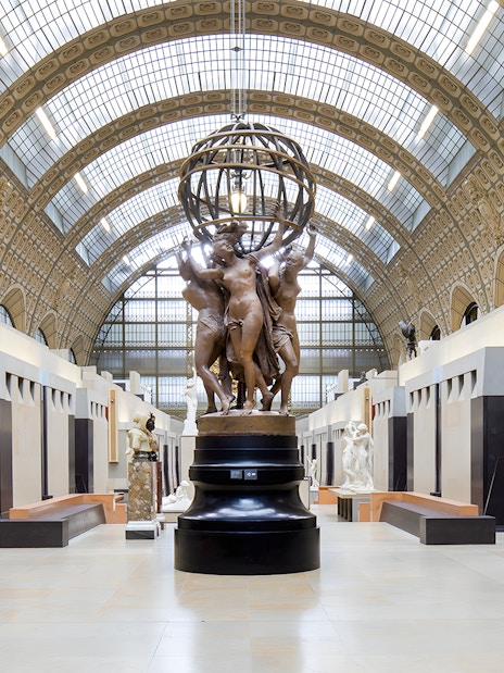 Visitors viewing sculptures in the grand hall of the Orsay Museum, Paris.