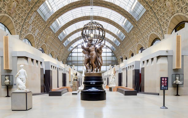 Visitors viewing sculptures in the grand hall of the Orsay Museum, Paris.