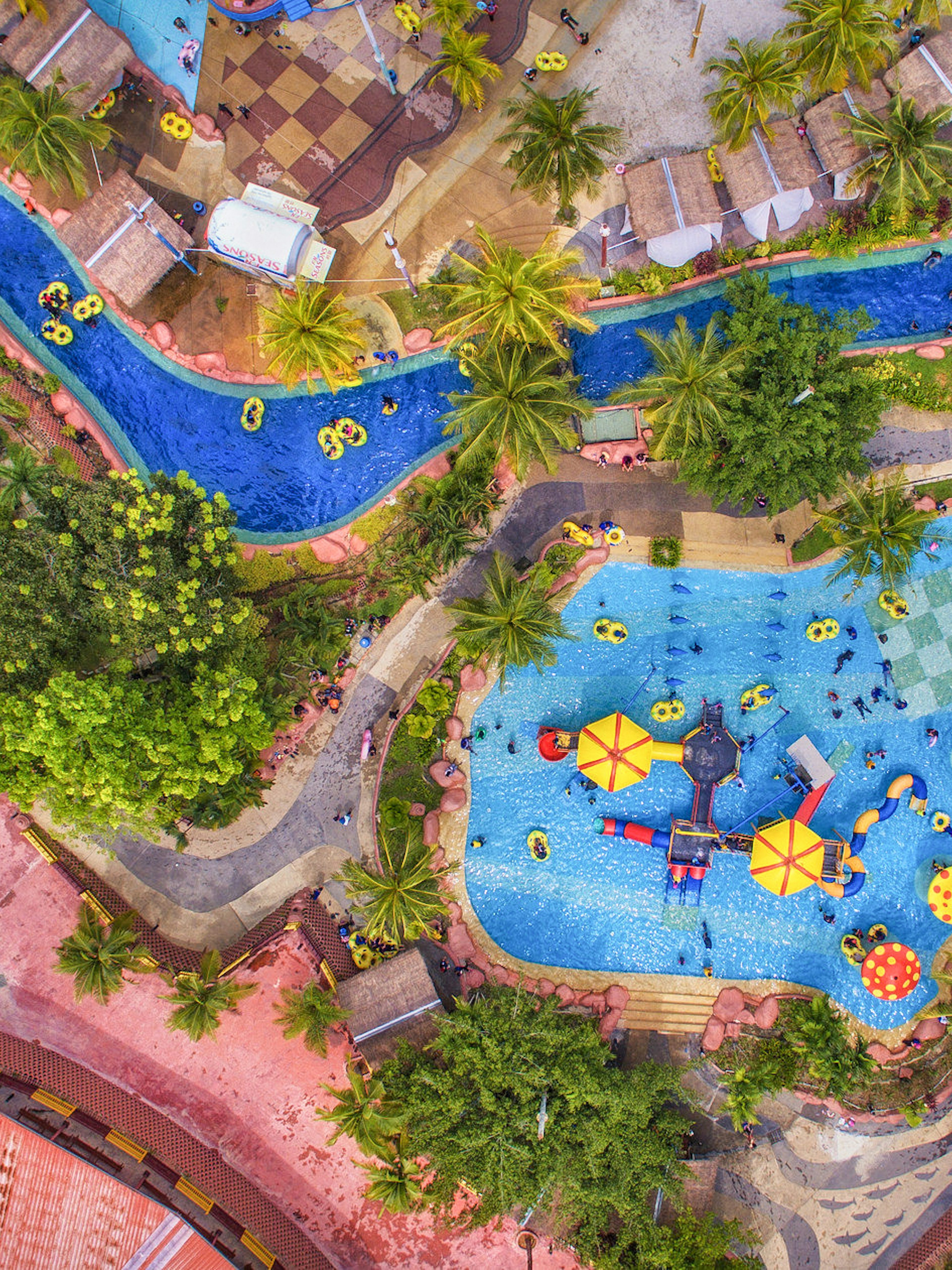 Aerial view of A'Famosa water park with pools, slides, and lush greenery.