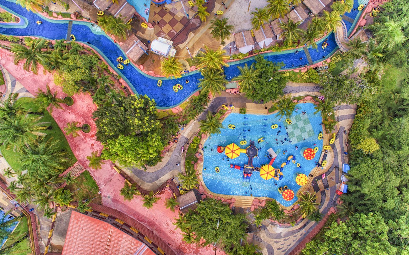 Aerial view of A'Famosa water park with pools, slides, and lush greenery.