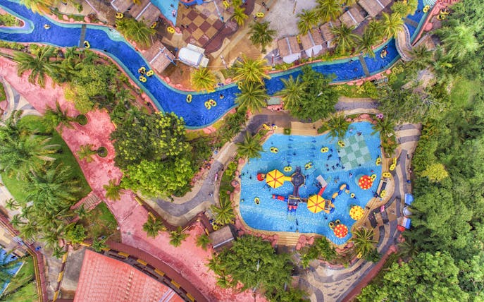 Aerial view of A'Famosa water park with pools, slides, and lush greenery.