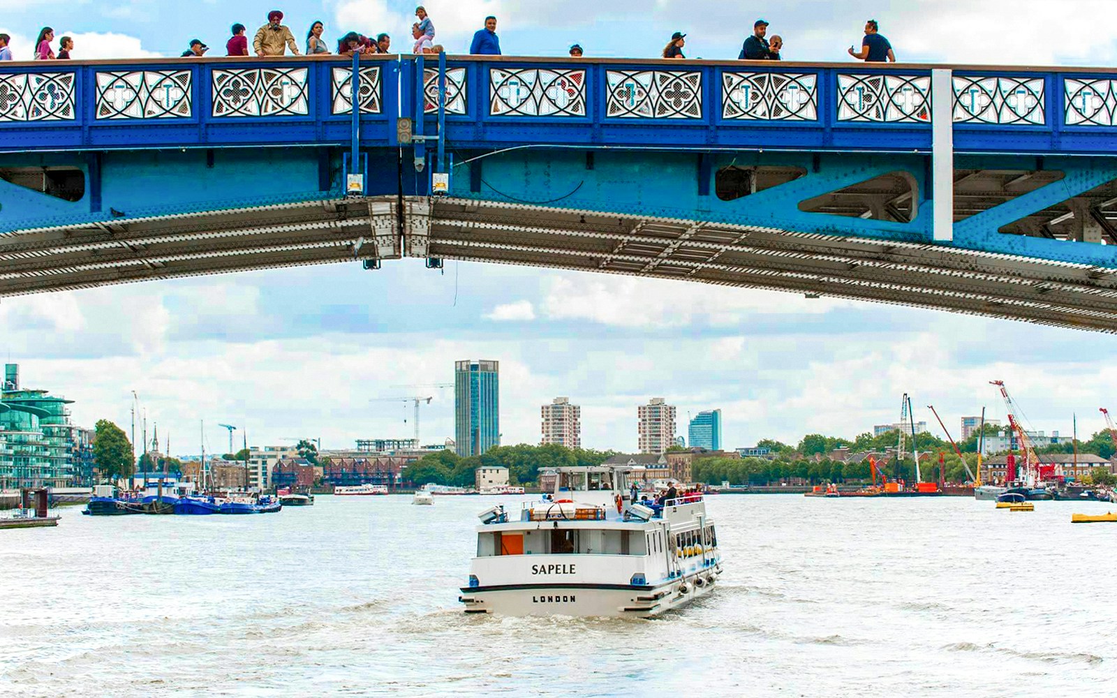 Tourists enjoying a Thames River Sightseeing Cruise from Westminster, offering unique views of London's landmarks