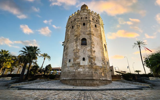 Golden Tower in Seville's Triana Quarter at sunset.