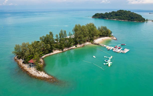 Aerial view of Paradise 101 private island with docks and turquoise waters.