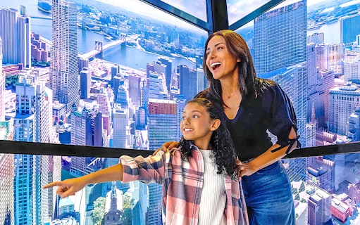 Visitors enjoying the view from One World Observatory in New York City.