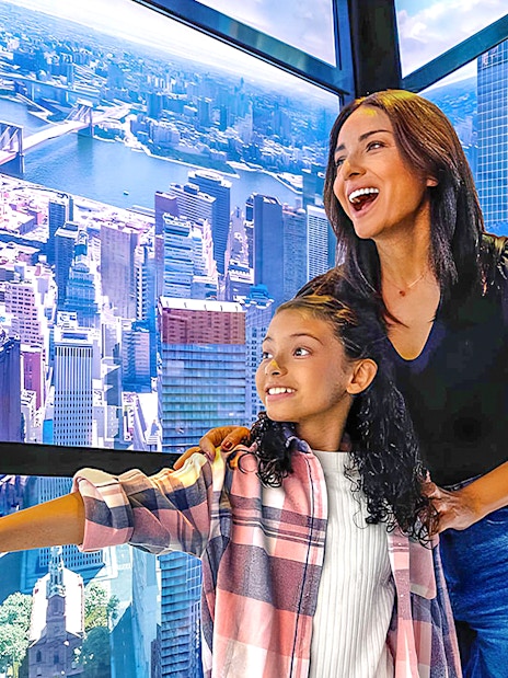 Visitors enjoying the view from One World Observatory in New York City.