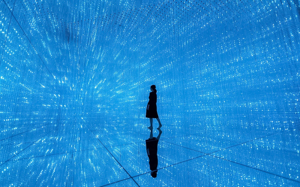 Silhouette in blue digital art installation at TeamLab Planets Tokyo.