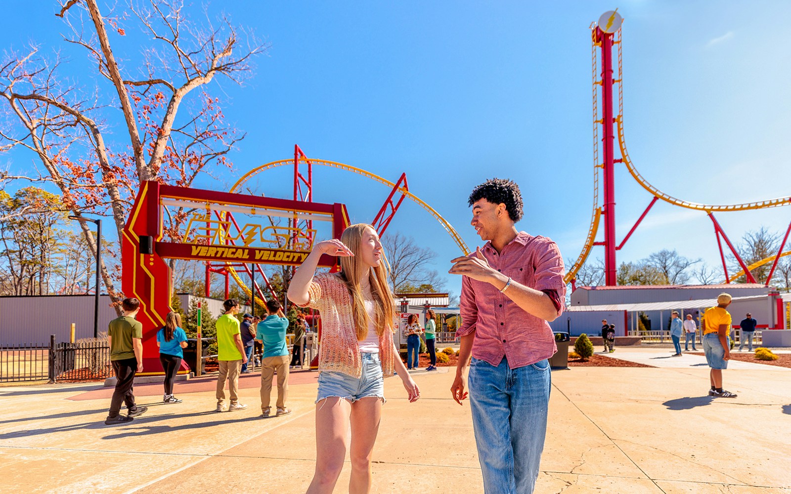 Visitors walking near THE FLASH™ Vertical Velocity ride at Six Flags Great Adventure.