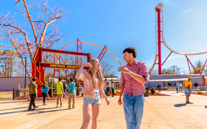 Visitors walking near THE FLASH™ Vertical Velocity ride at Six Flags Great Adventure.